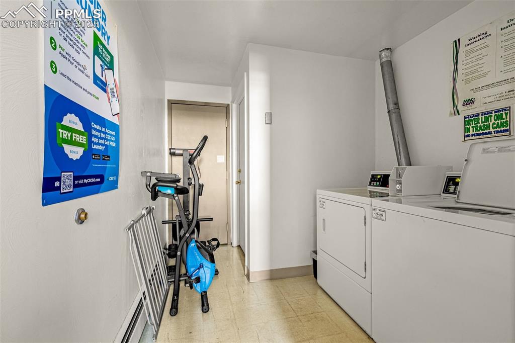 Image 14 of 15: Shared laundry room with washer and clothes dryer