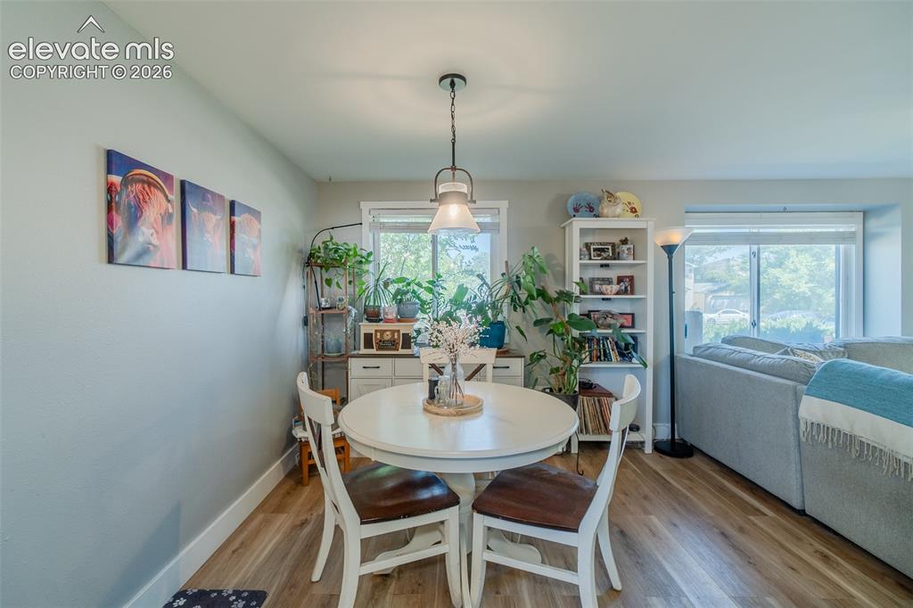 Image 10 of 31: Dining area featuring wood-finish flooring, a pendant light fixture, and ab