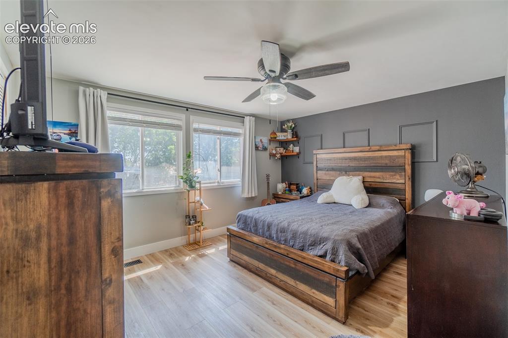 Image 17 of 31: Room featuring light wood-finish flooring and a ceiling fan with integrated