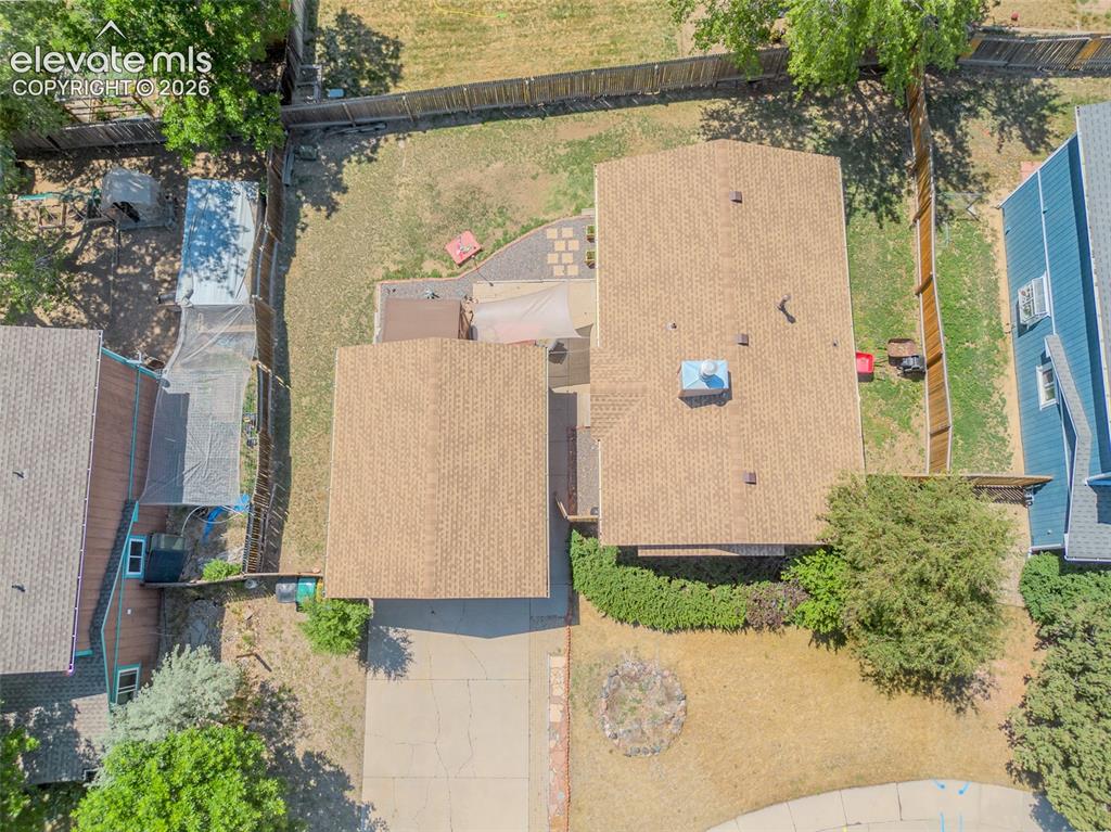 Image 28 of 31: Property features a brown shingle roof and an expansive driveway