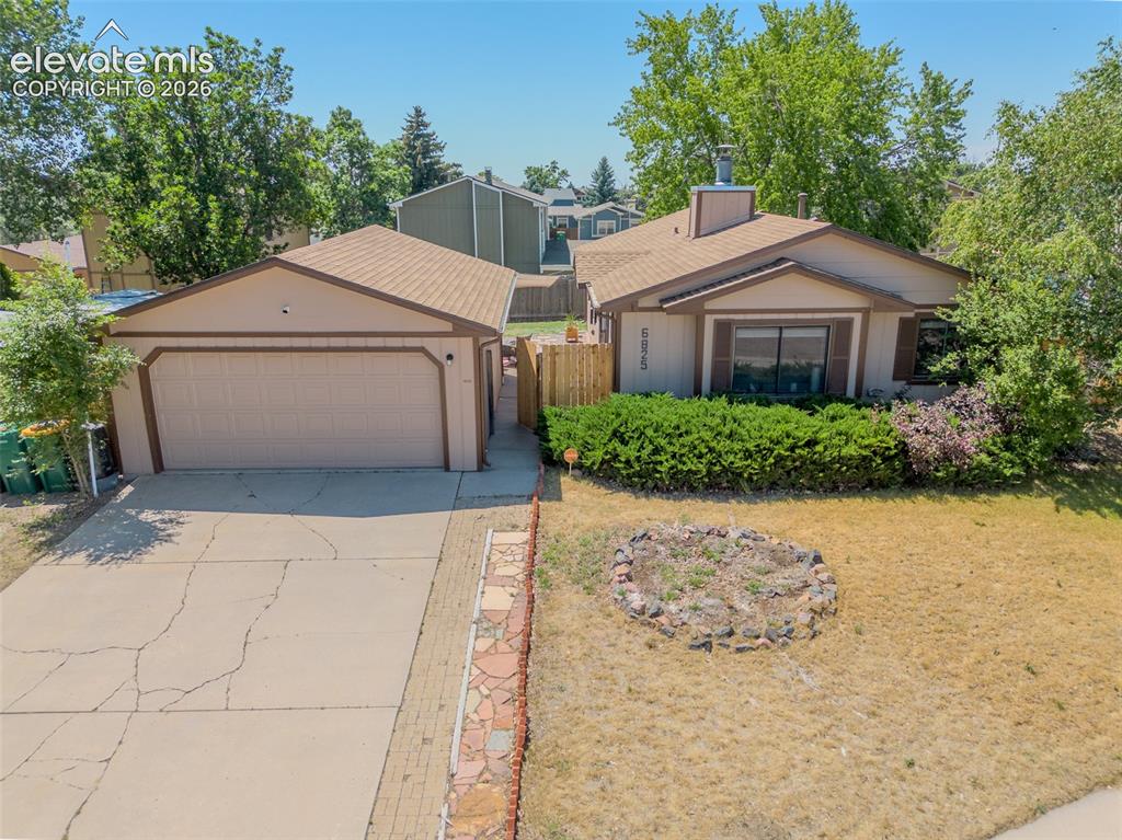 Image 31 of 31: Ranch-style residence featuring an attached garage with a tan overhead door