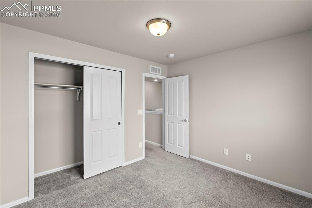 Image 20 of 43: Unfurnished bedroom with light colored carpet and a closet