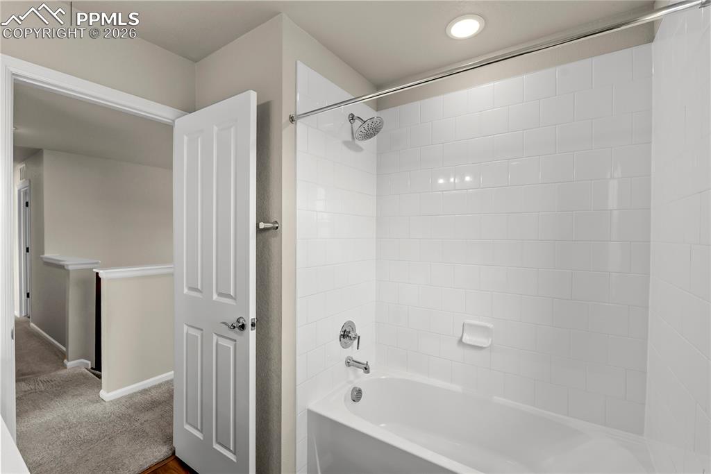 Image 22 of 43: Upper level full bathroom with shower/tub combo
