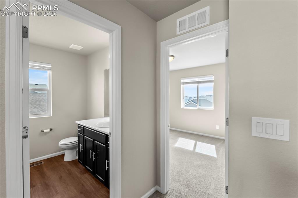 Image 23 of 43: Secondary Bathroom on Upper Level with vanity and standing shower