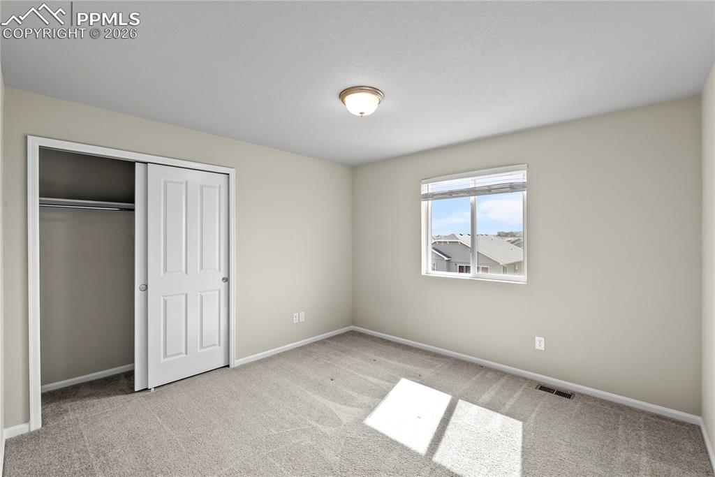 Image 25 of 43: Unfurnished bedroom with a closet and light carpet