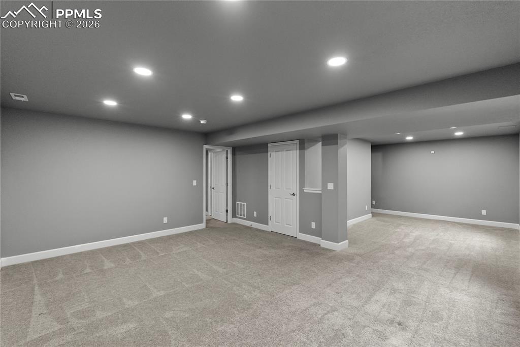 Image 29 of 43: Finished below grade area with recessed lighting and light carpet