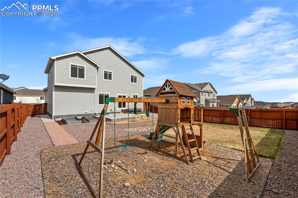 Image 32 of 43: Play Set included! maintained backyard with a privacy fence
