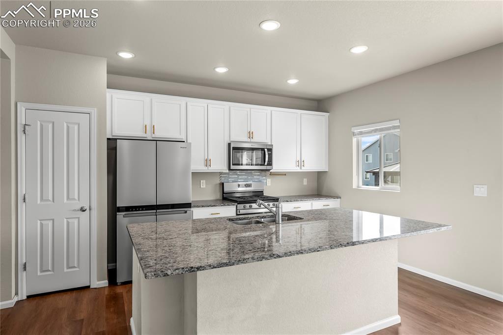 Image 7 of 43: Gorgeous Kitchen with white cabinets, stainless steel appliances, gas oven,