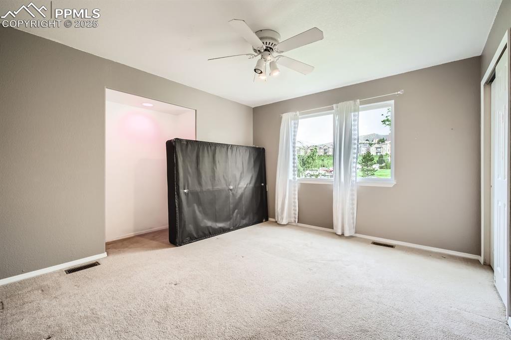 Image 11 of 18: Spare room with ceiling fan and carpet