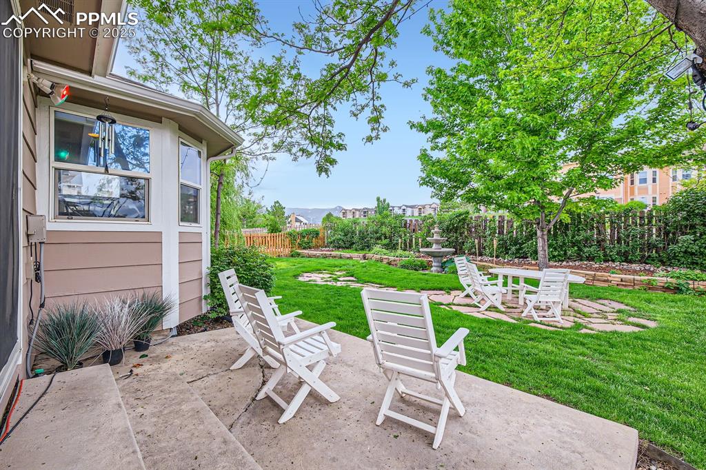 Image 17 of 18: Fenced backyard featuring a patio area