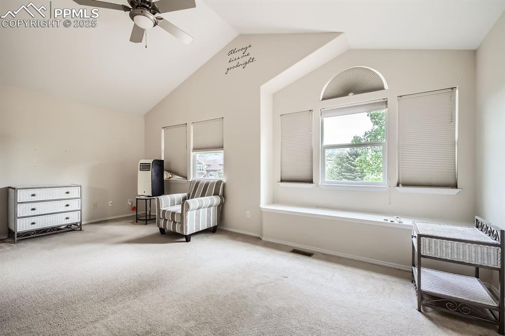 Image 8 of 18: Living area with lofted ceiling, a ceiling fan, and carpet floors