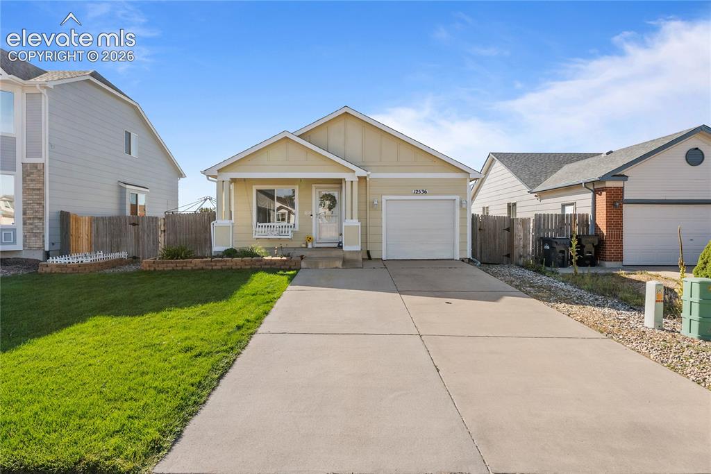 Image 1 of 42: Single-story residence featuring a covered front porch, an attached garage,
