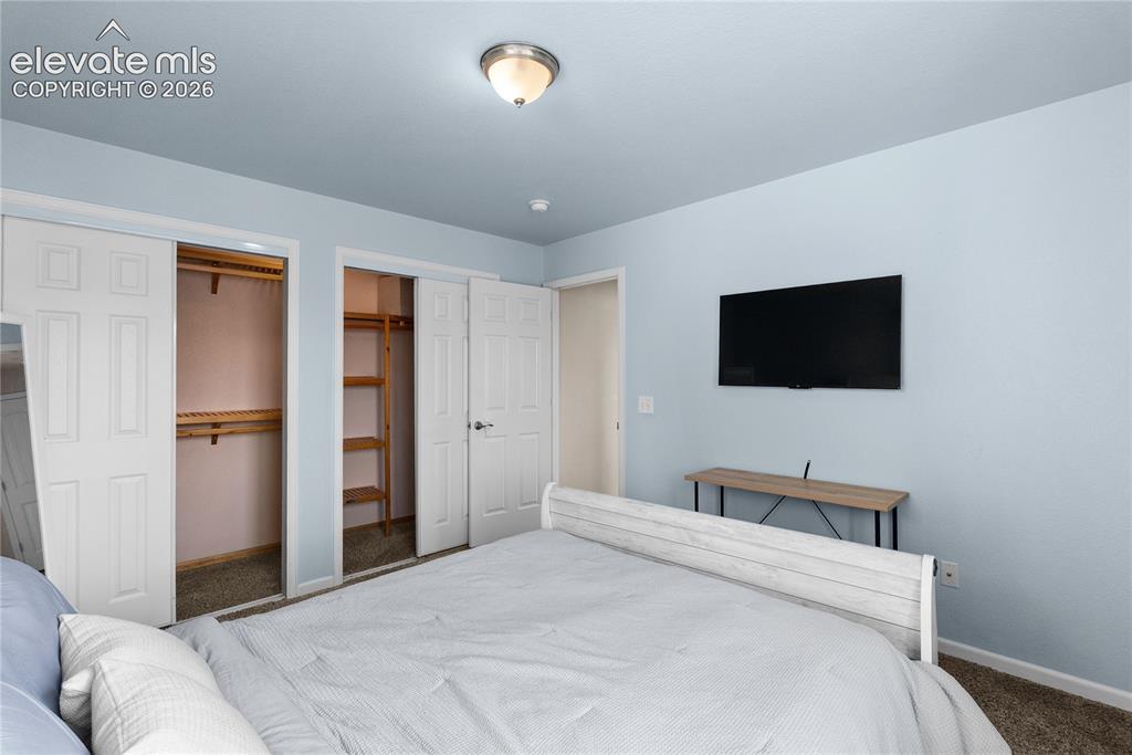 Image 11 of 42: Bedroom featuring a flush-mount ceiling light, light blue walls, and carpet