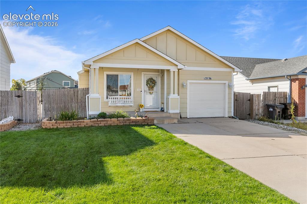 Image 2 of 42: Single-story residence featuring a covered front porch, an attached single-