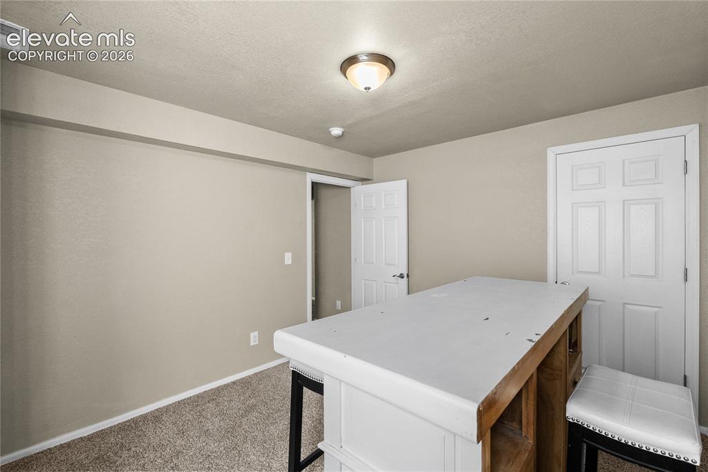 Image 25 of 42: Carpeted flooring with painted walls