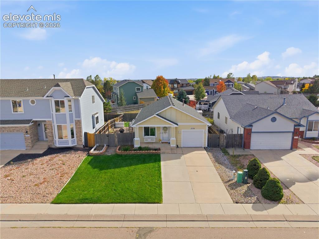 Image 36 of 42: Single-story residence featuring an attached garage, concrete driveway, and