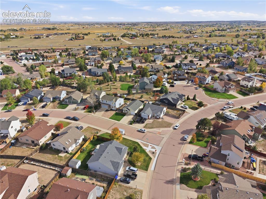 Image 39 of 42: Residential development with paved roads, established homes, and surroundin