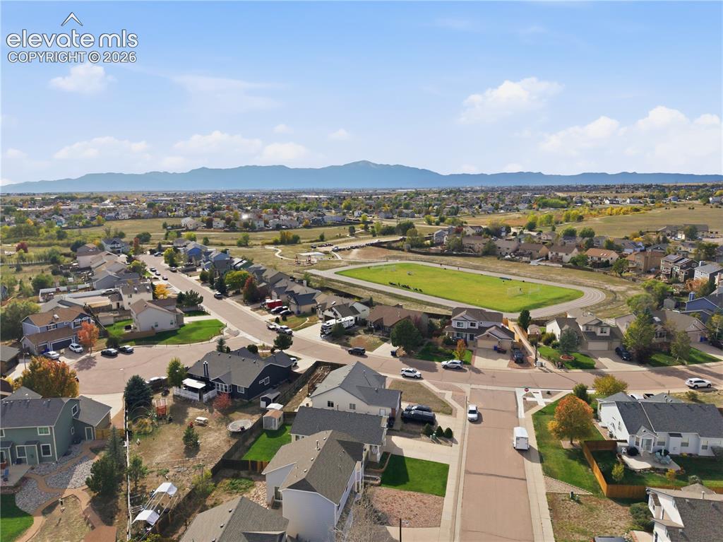 Image 41 of 42: Residential neighborhood with diverse home styles, paved streets, and a pro