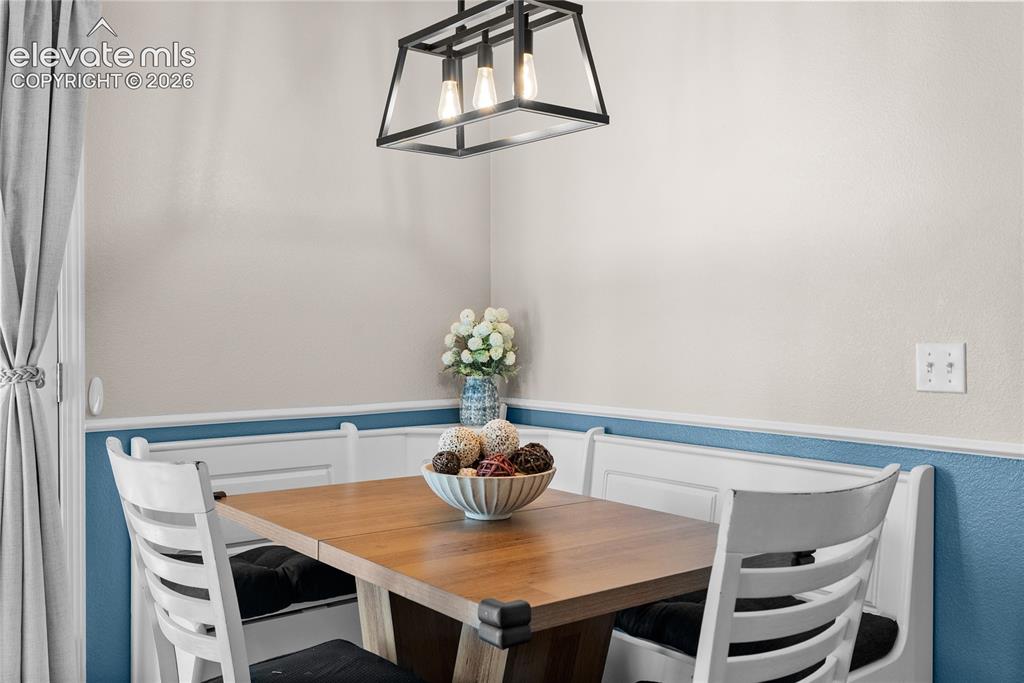 Image 7 of 42: Built-in corner bench seating with wainscoting detail