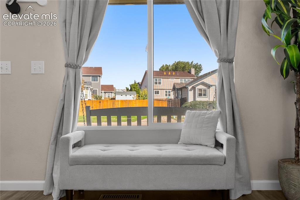 Image 8 of 42: Window with light-colored curtains and a built-in window bench