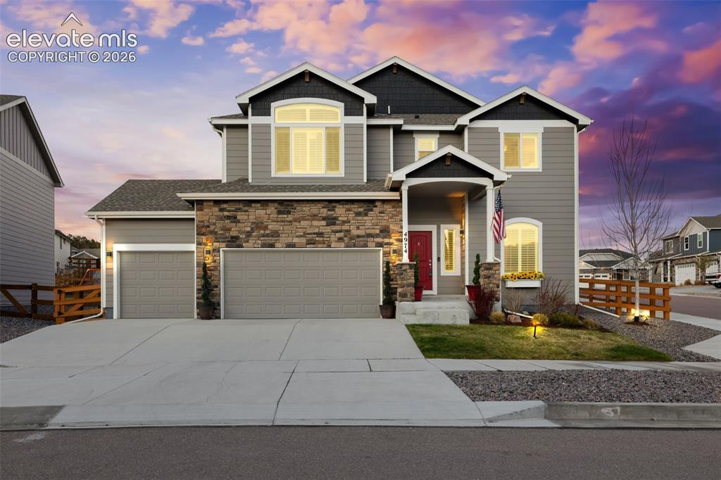 Image 1 of 43: Siding exterior with stone accents, covered entry, and two-car garage