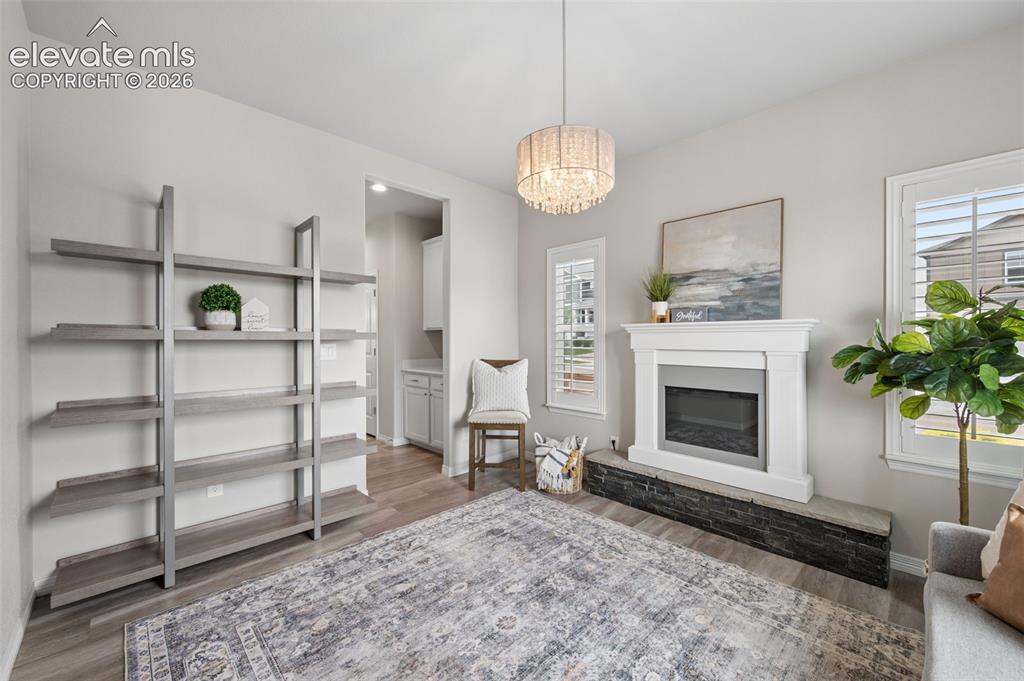 Image 13 of 43: Contemporary fireplace with white mantel and dark stone hearth, wood-finish