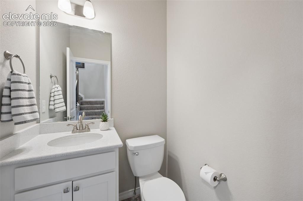 Image 15 of 43: White vanity with a single basin sink, brushed nickel faucet, and a large w