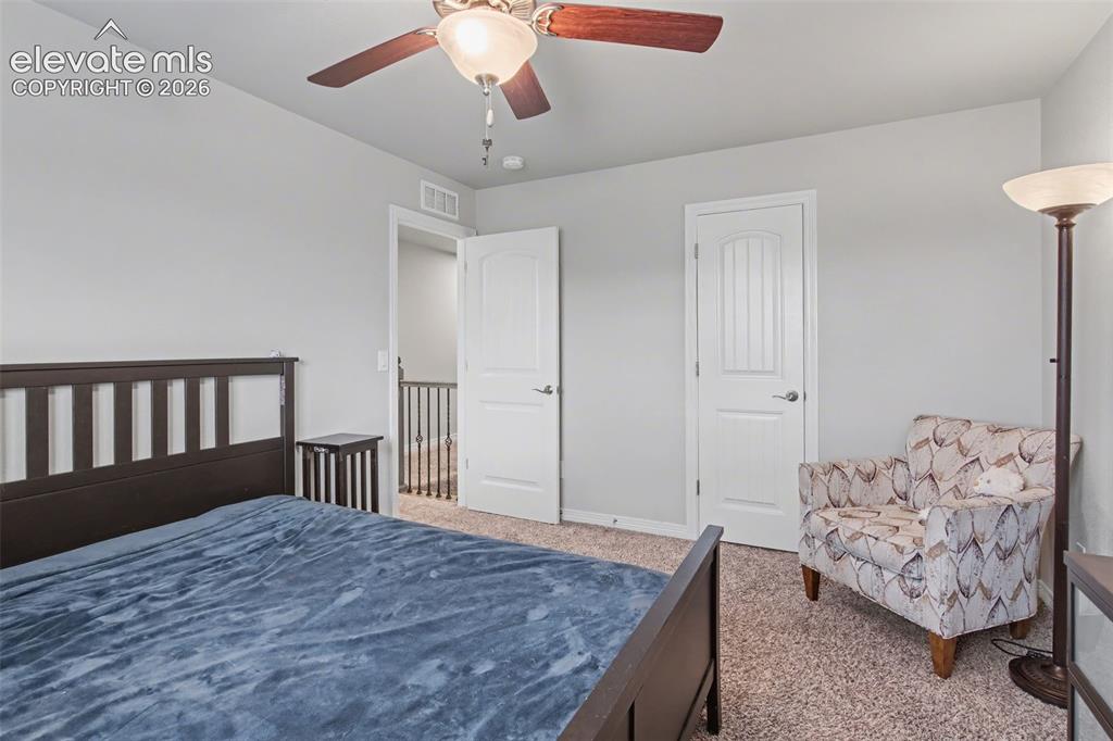 Image 25 of 43: Carpeted flooring, ceiling fan with integrated lighting, and white interior