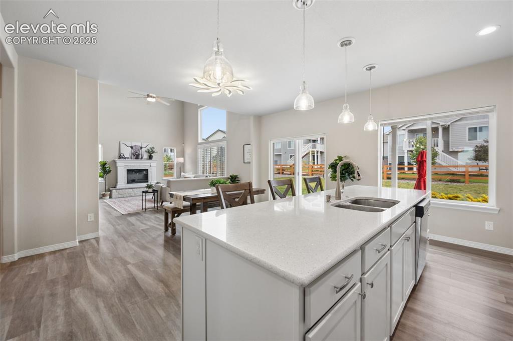 Image 4 of 43: Open-concept kitchen and living area featuring a large center island with a
