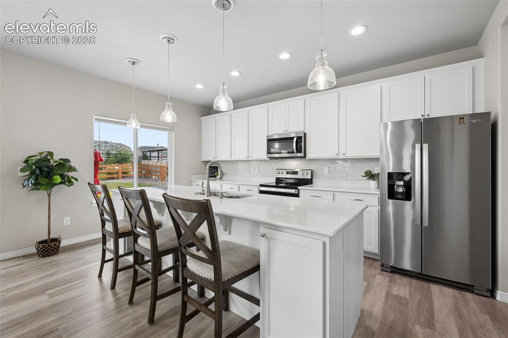 Image 5 of 43: White cabinetry with brushed nickel hardware, stainless steel appliances, c