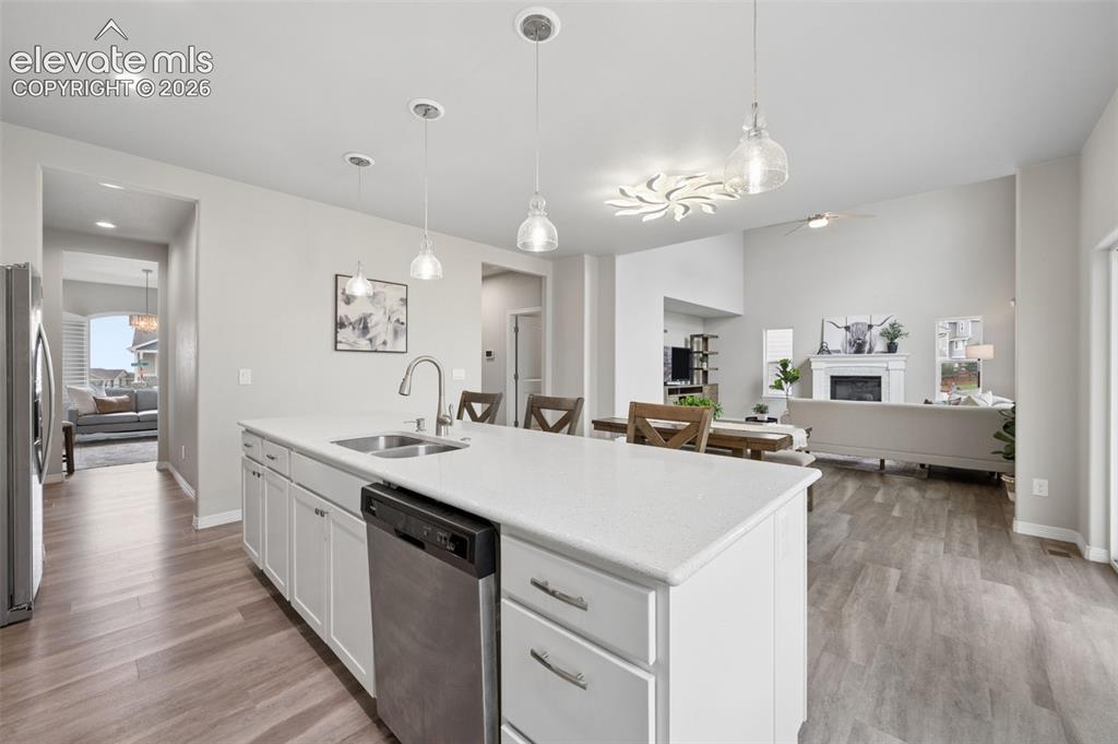 Image 7 of 43: Open-concept kitchen and living area featuring a large center island with i