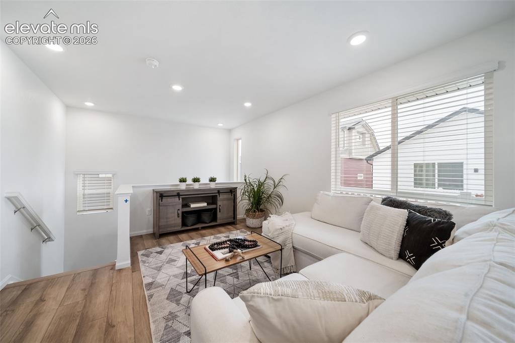 Image 8 of 25: Spacious upper-level living area featuring recessed lighting and wood-finis