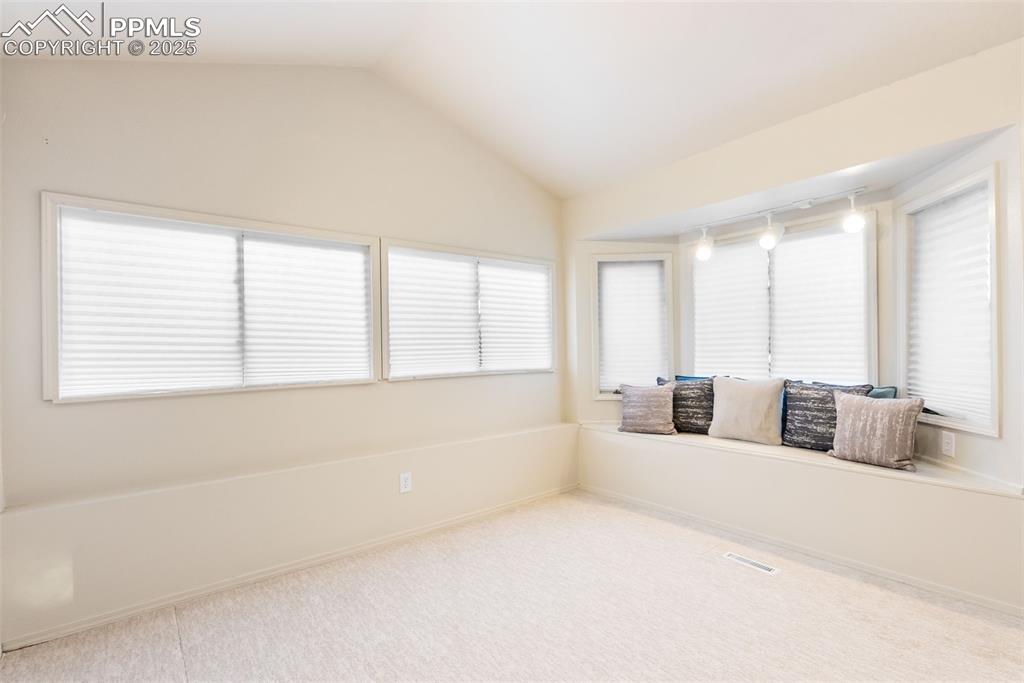 Image 19 of 50: Unfurnished sunroom featuring lofted ceiling and track lighting