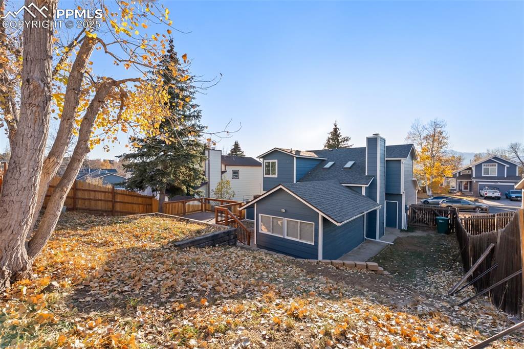 Image 36 of 50: Rear view of property with roof with shingles, a fenced backyard, and a chi