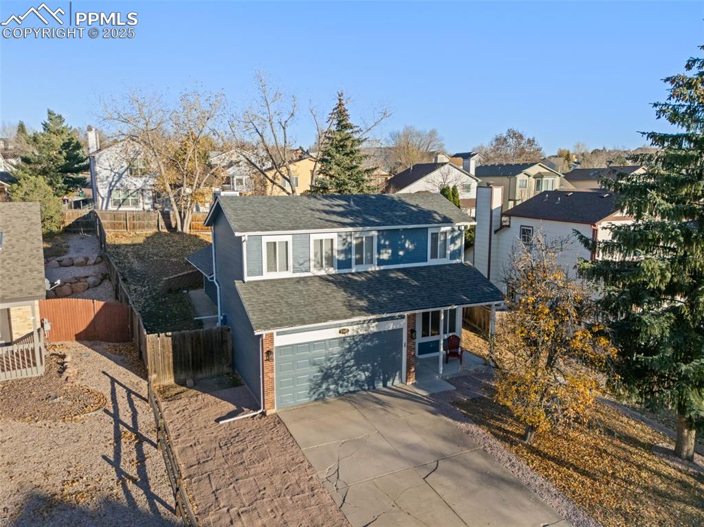 Image 43 of 50: Traditional-style house featuring a shingled roof, brick siding, concrete d