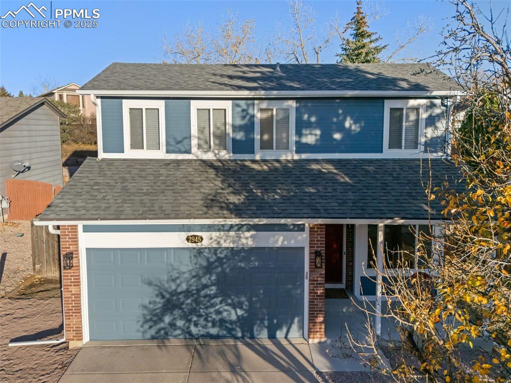 Image 44 of 50: View of front of home with brick siding, roof with shingles, concrete drive