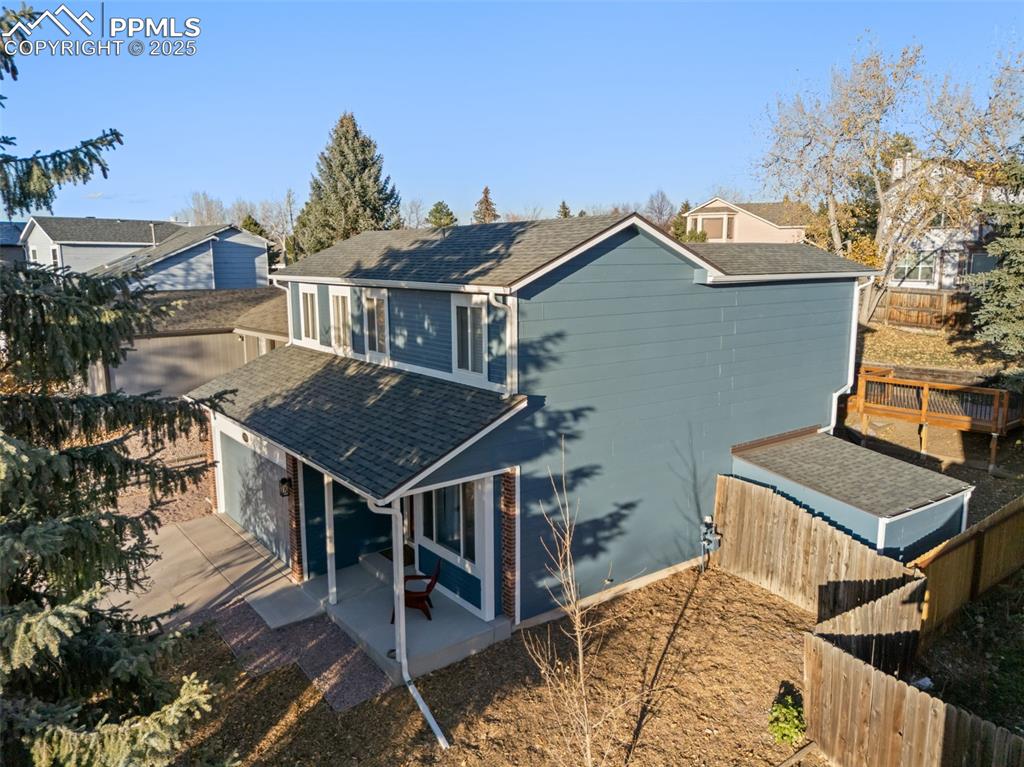 Image 46 of 50: Back of house with roof with shingles, a fenced backyard, and a patio area