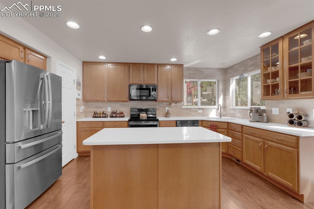 Image 10 of 43: Kitchen featuring backsplash, and an island.