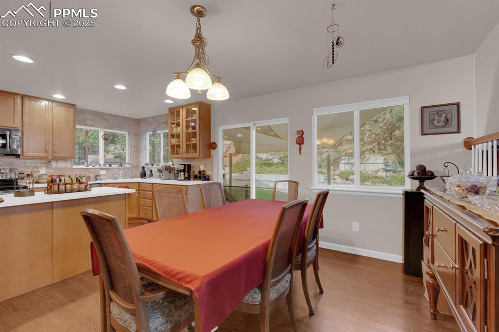 Image 12 of 43: Dining Area featuring hardwood floors and walkout to huge patio