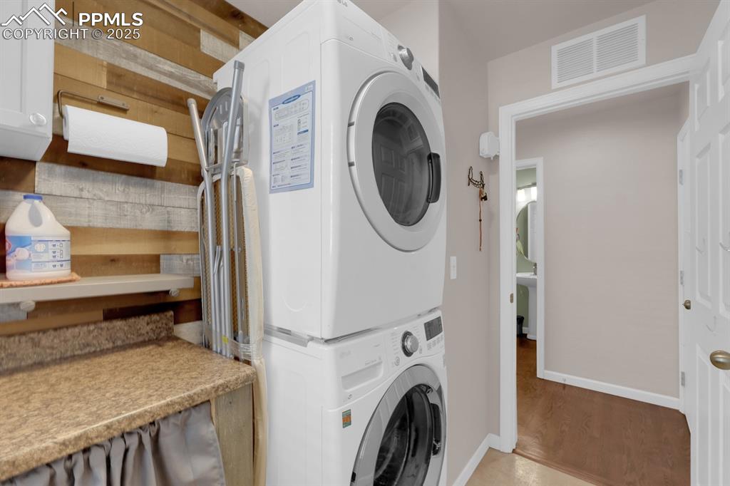 Image 16 of 43: Laundry Room with stacked washer and dryer