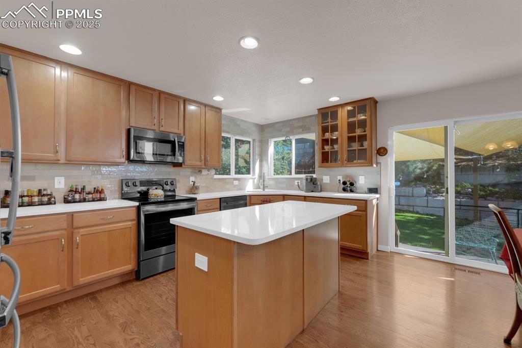 Image 2 of 43: Kitchen with Corian tops and walk-out 