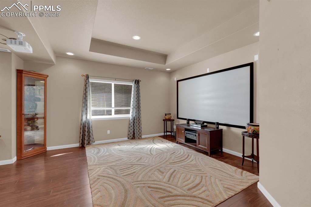 Image 27 of 43: Large Basement Family Room with coffered ceiling