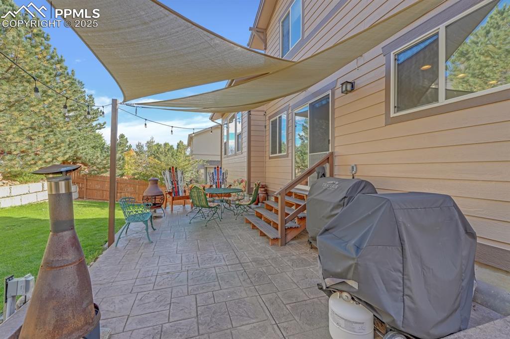 Image 35 of 43: Backyard with stamped concrete patio
