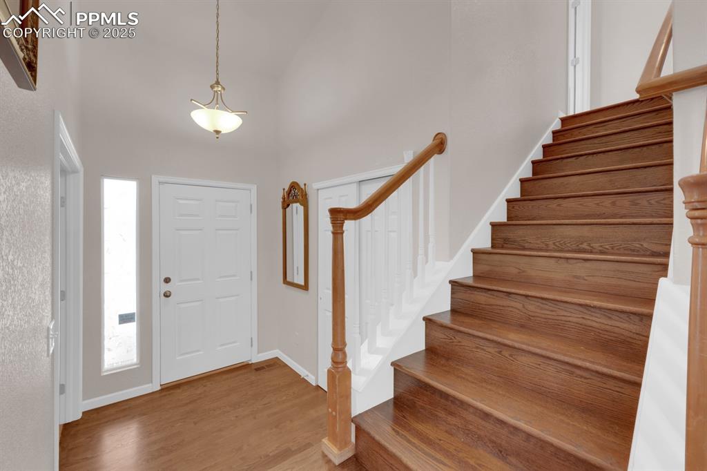 Image 7 of 43: Entrance foyer featuring hardwood floors and a coat closet