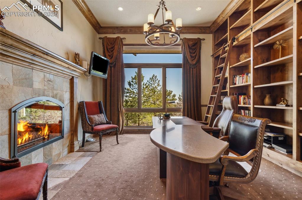 Image 17 of 50: Office/study/library with gas fireplace, crown molding, built-in bookcases 