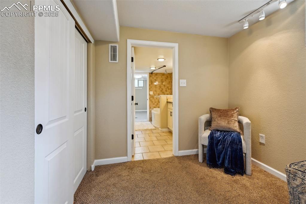 Image 23 of 31: The bonus room can be used for an office, dressing room, storage space, and