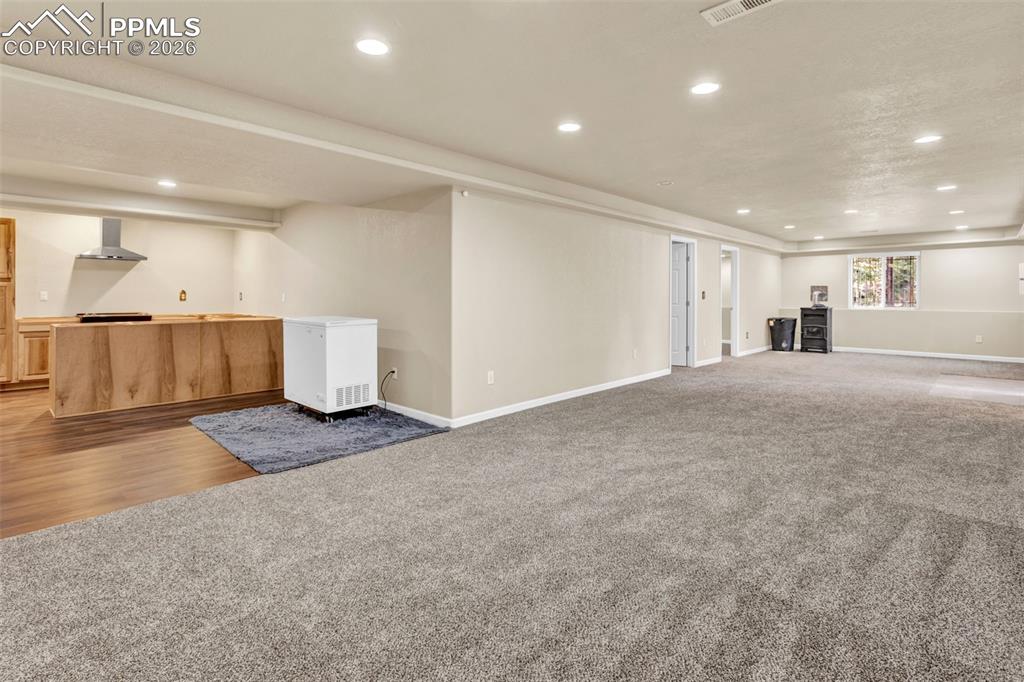 Image 24 of 30: Basement open area and kitchen