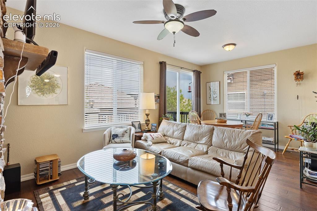 Image 14 of 28: Living area featuring wood-finish flooring and multiple windows
