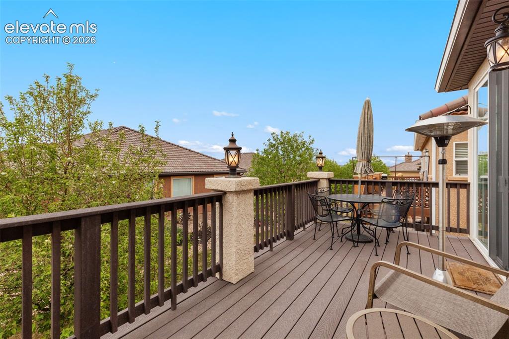 Image 19 of 28: Looking east. Expansive outdoor deck featuring composite decking, dark wood
