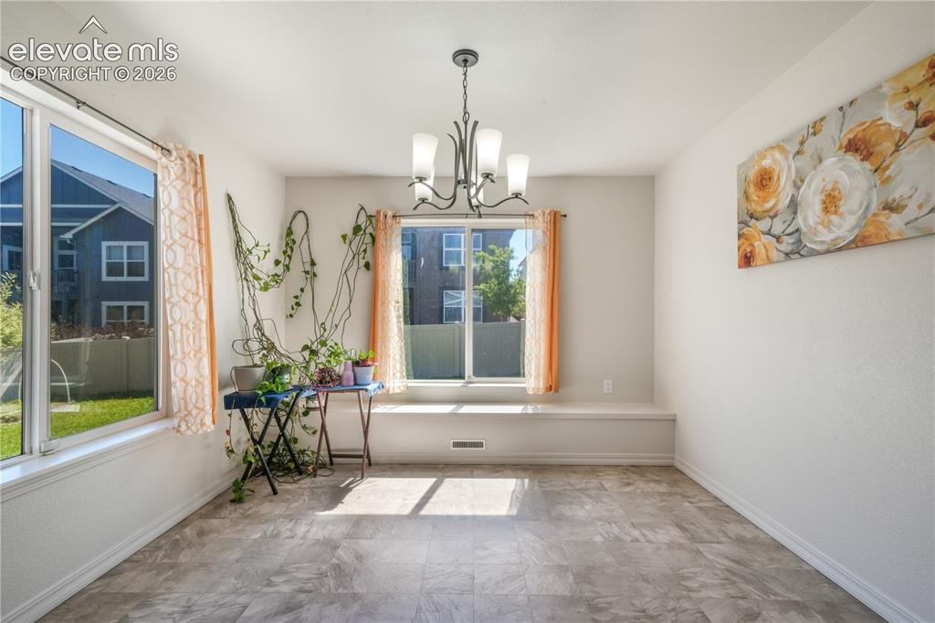 Image 13 of 50: Dining area with large windows
